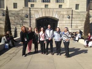 Students and faculty pose in front of the Nebraska Capitol